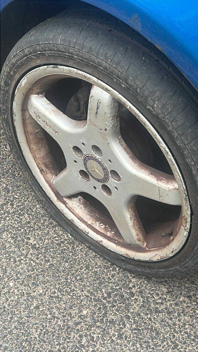 Before: a worn tyre on a silver five spoke alloy